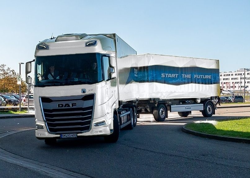 White DAF XG truck with a drawbar trailer on the road